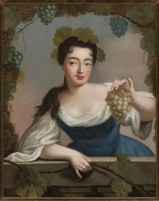 Woman with a bunch of grapes
